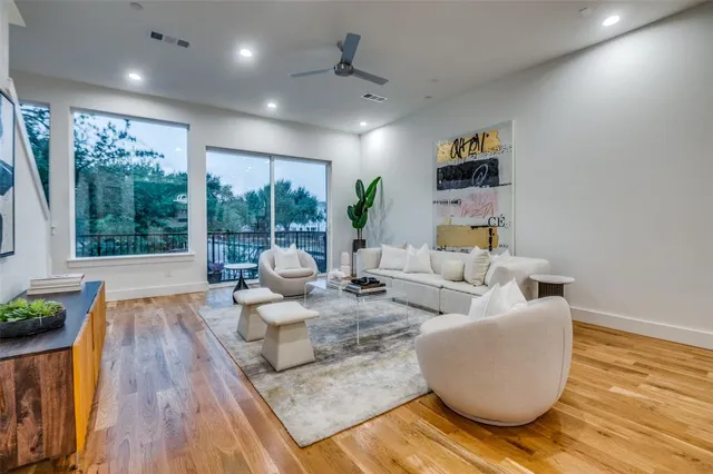 a living room with fireplace furniture and a wooden floor