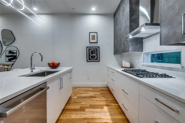 a large kitchen with stainless steel appliances granite countertop a sink and cabinets