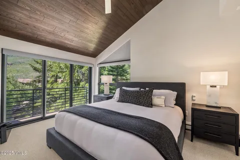 a bedroom with a large bed and a large window