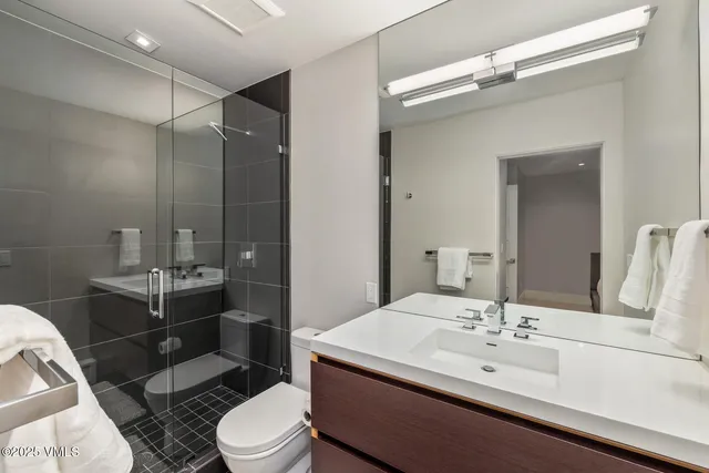 a bathroom with a sink toilet and shower