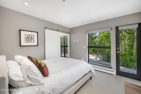 a bedroom with a bed and a large window