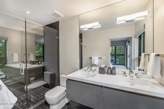 a bathroom with a sink toilet and shower