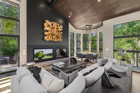 a living room with fireplace furniture and a large window