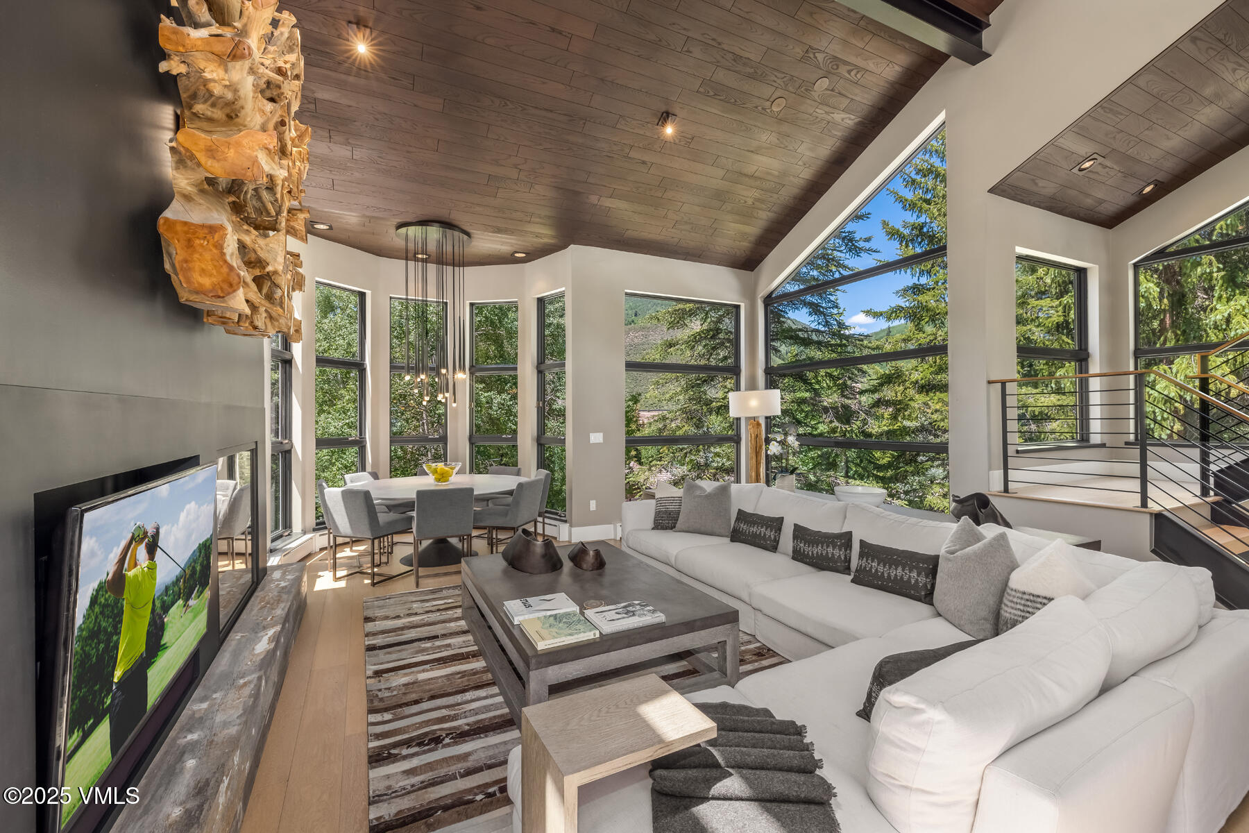 327 Rockledge Road, Unit W Vail, CO 81657 - Photo 8 of 31 a living room with furniture floor to ceiling window and a flat screen tv