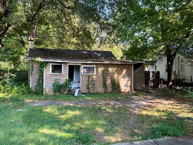 a view of backyard of house with green space