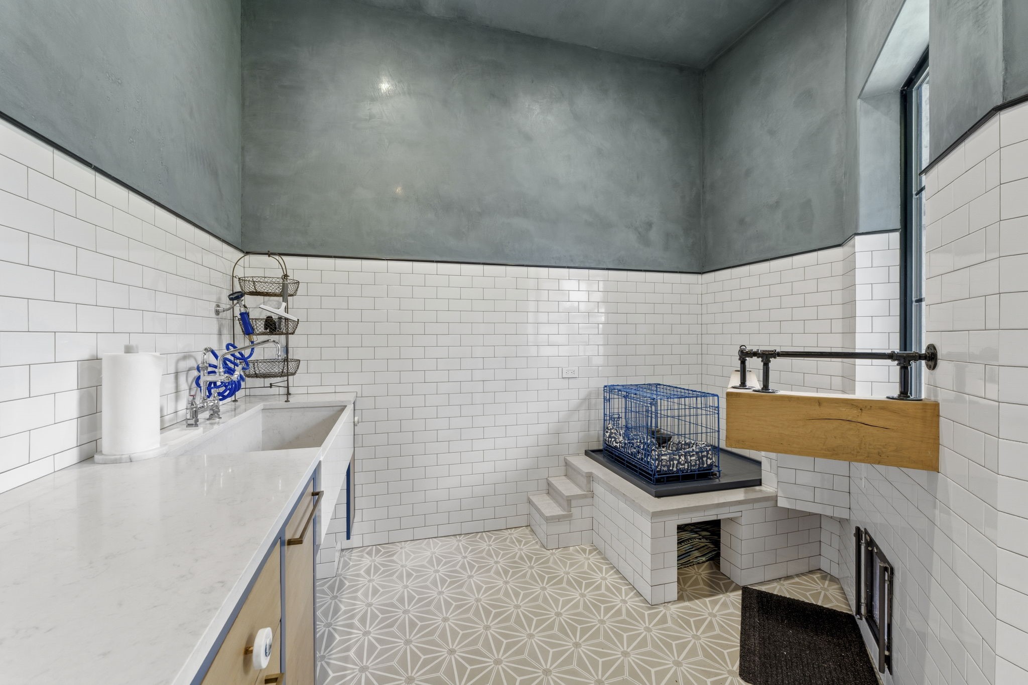 27006 Star Gazer Way Spring, TX 77386 - Photo 34 of 50 A custom pet suite designed with comfort and convenience in mind, featuring a built-in dog house with window seat and steps, dedicated dog wash station, Dutch door, fenced yard access, floor drain, and stylish cement tile finishes.