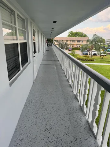 a front view of a house with a garden and plants
