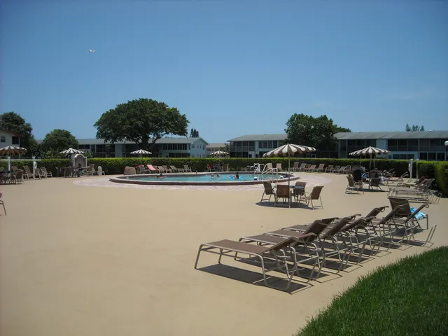 a view of a lake with lawn chairs