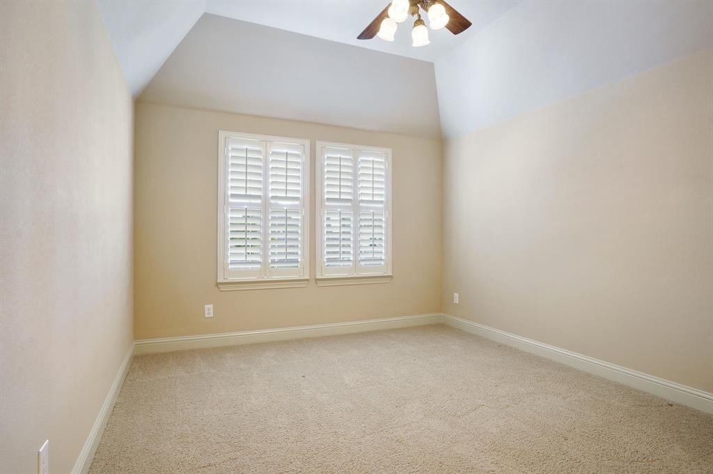 9106 Cochran Bluff Lane Dallas, TX 75220 - Photo 33 of 40 Empty room with carpet flooring, ceiling fan, and vaulted ceiling