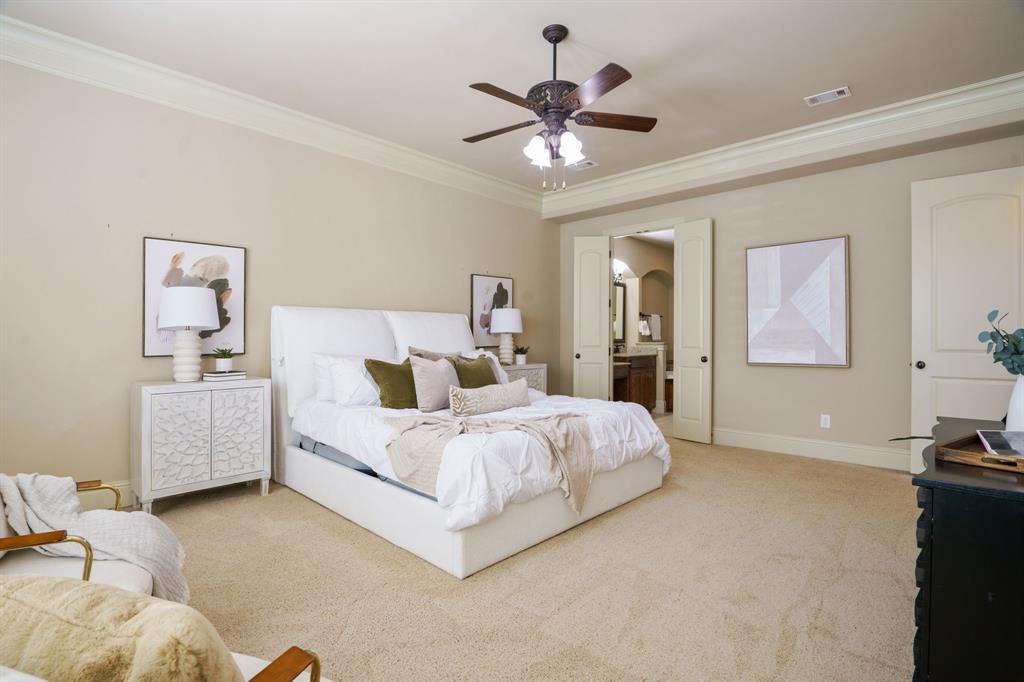 9106 Cochran Bluff Lane Dallas, TX 75220 - Photo 37 of 40 Carpeted bedroom with ornamental molding, ceiling fan, and ensuite bathroom