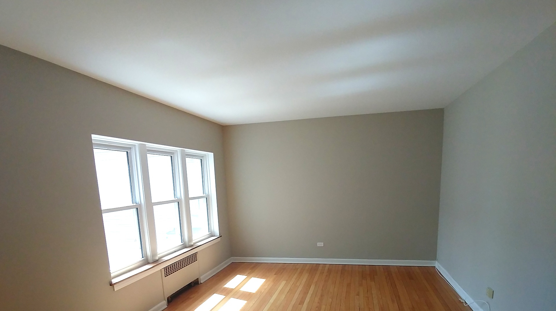 100 Pine Avenue, Unit 2 Riverside, IL 60546 - Photo 7 of 12 an empty room with wooden floor and windows
