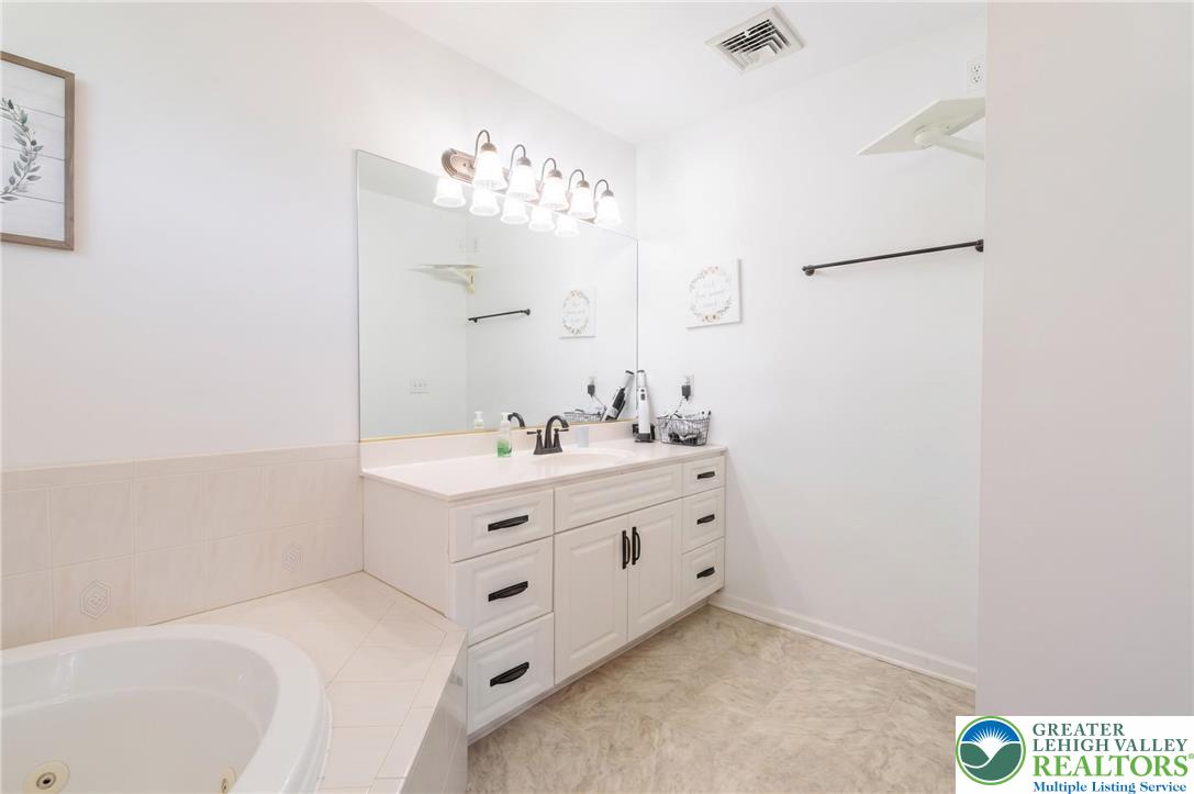1089 Deemer Road Bath, PA 18014 - Photo 23 of 57 Bright and airy, this bathroom offers a functional vanity and a relaxing soaking tub.