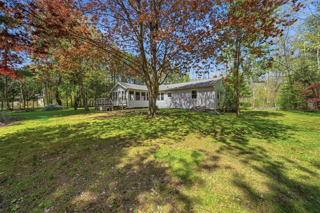322 Rocky Hill Road Scituate, RI 02857 - Photo 44 of 50 Step into your own private retreat with this serene, tree-lined backyard in North Scituate. Surrounded by mature trees and beautiful flowering shrubs, the setting feels peaceful and tucked away.