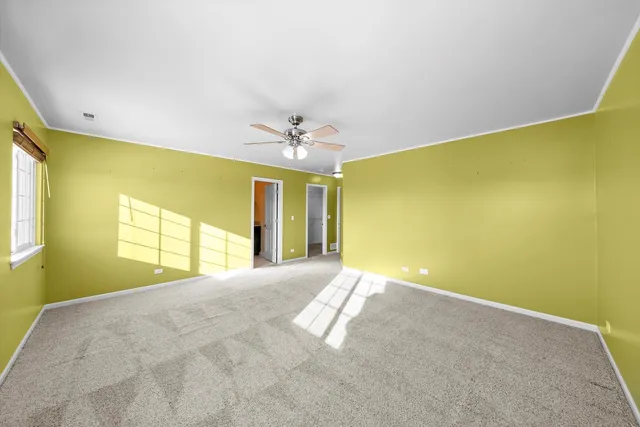 a view of a big room with windows and chandelier
