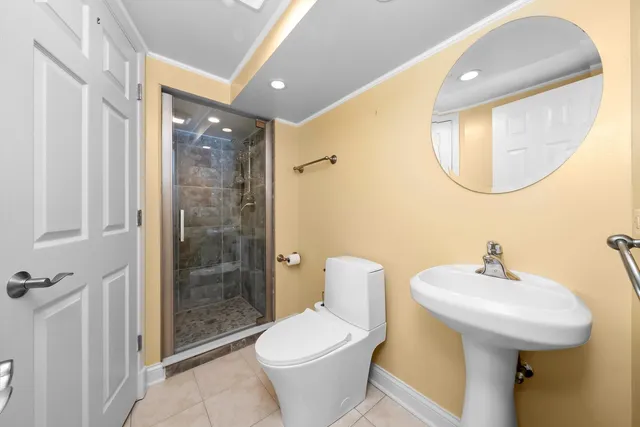 a bathroom with a sink toilet and shower