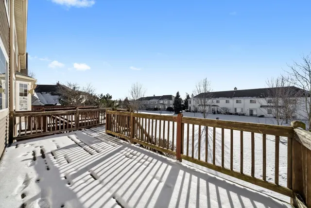 a view of balcony with wooden floor and fence