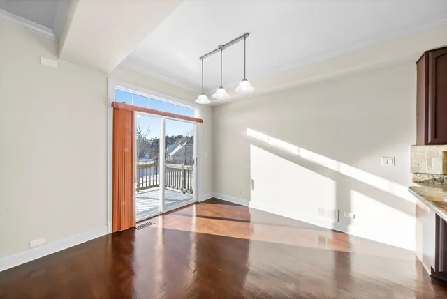 a view of an entryway with wooden floor