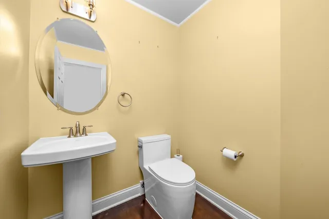 a bathroom with a sink mirror and toilet