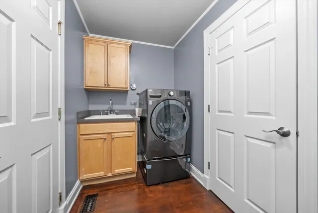 a utility room with sink dryer and washer