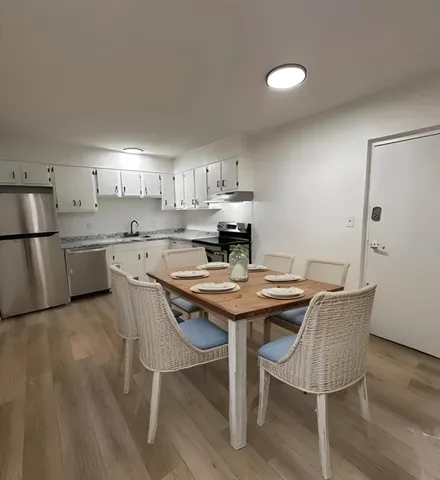 a view of a kitchen with a table and chairs