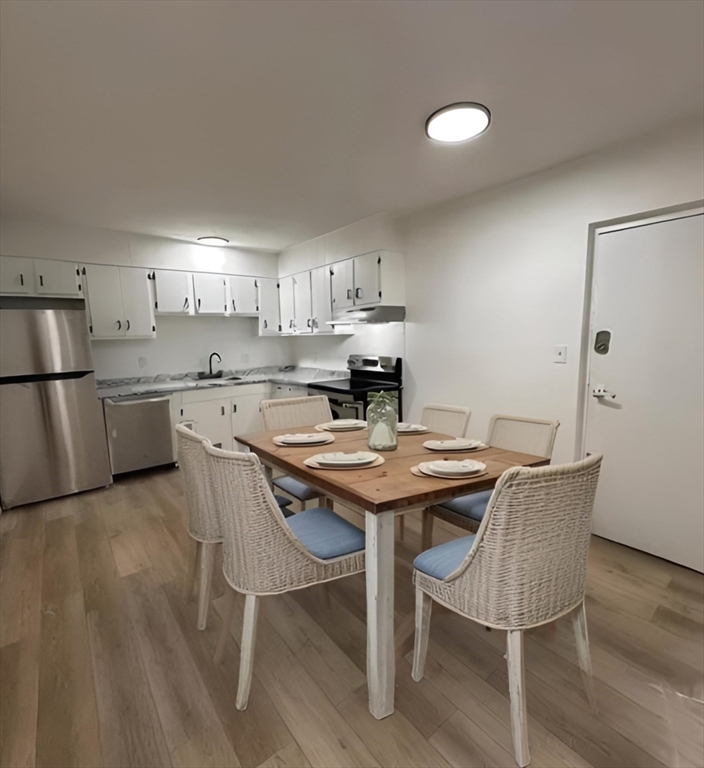 a view of a kitchen with a table and chairs