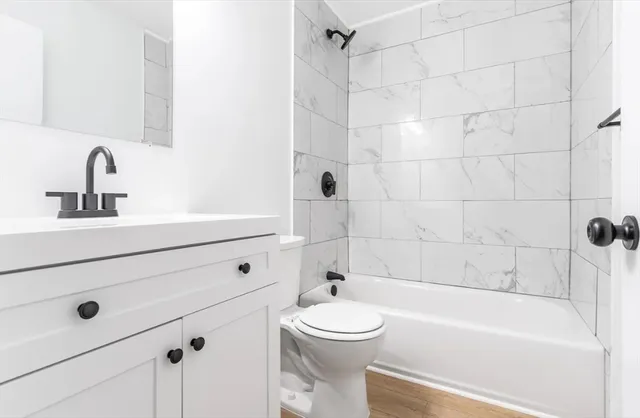 a bathroom with a sink a toilet and bathtub