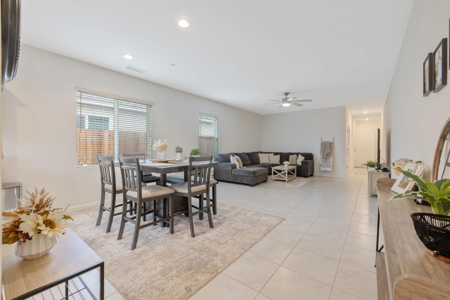 535 Sandtrap Lane Lemoore, CA 93245 - Photo 12 of 36 a living room with furniture a dining table and a potted plant