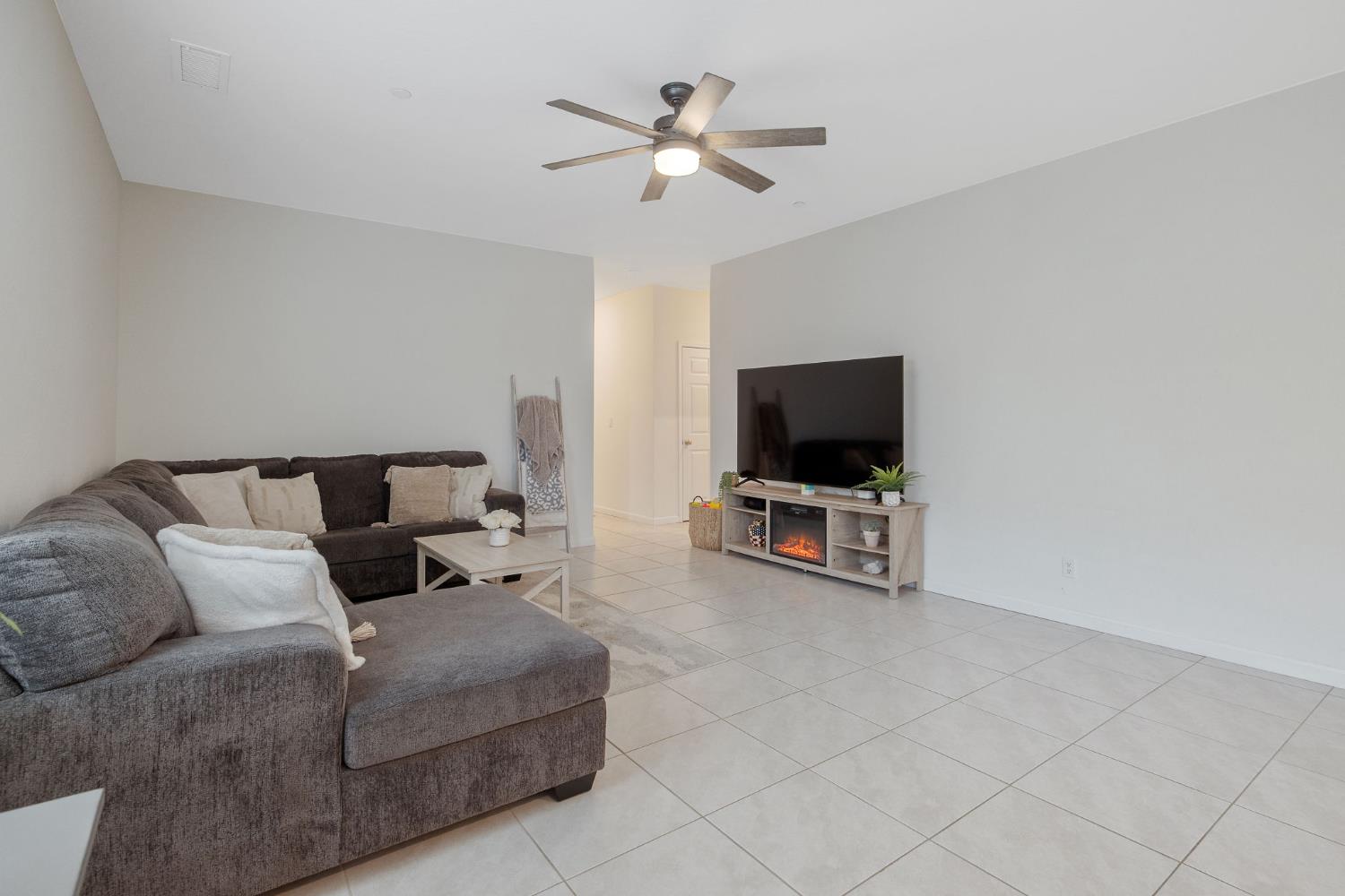 535 Sandtrap Lane Lemoore, CA 93245 - Photo 15 of 36 a living room with furniture and a flat screen tv