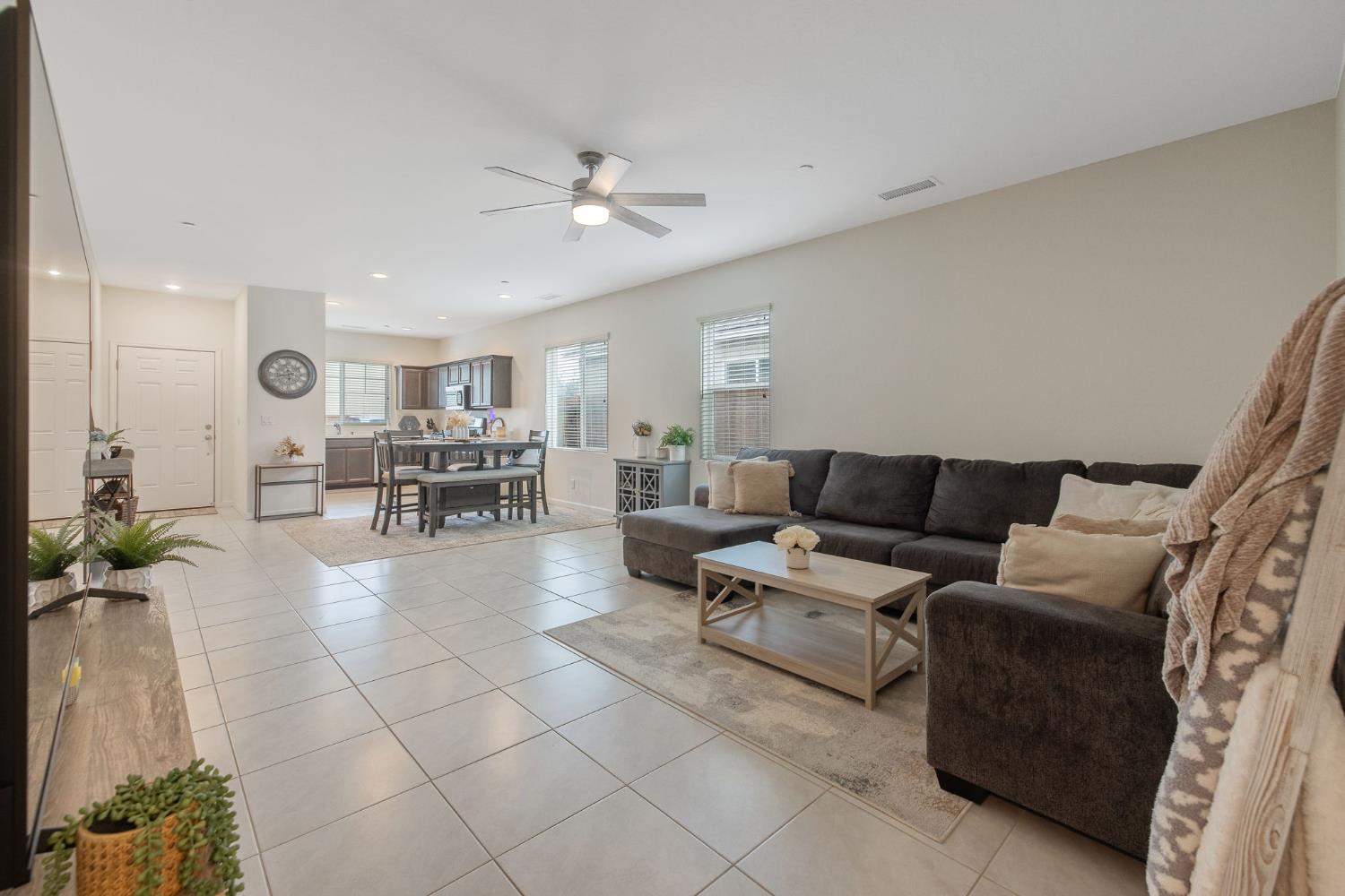 535 Sandtrap Lane Lemoore, CA 93245 - Photo 16 of 36 a living room with furniture and a dining table with kitchen view