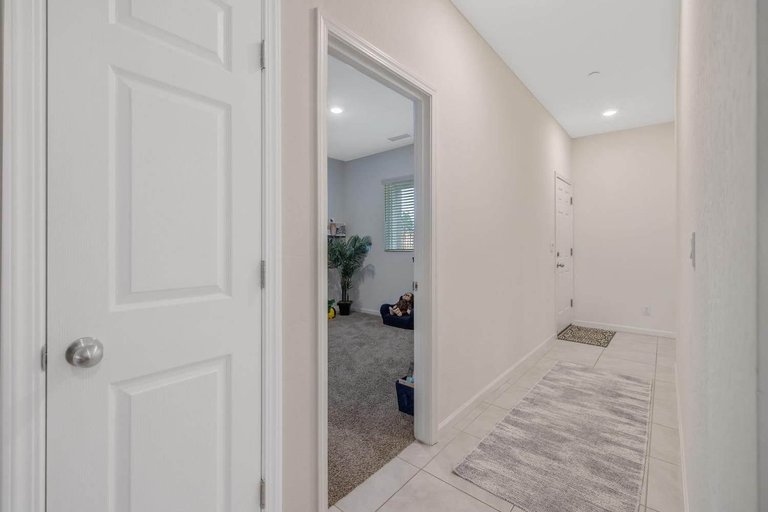 535 Sandtrap Lane Lemoore, CA 93245 - Photo 22 of 36 a view of a hallway with closet and wooden floor