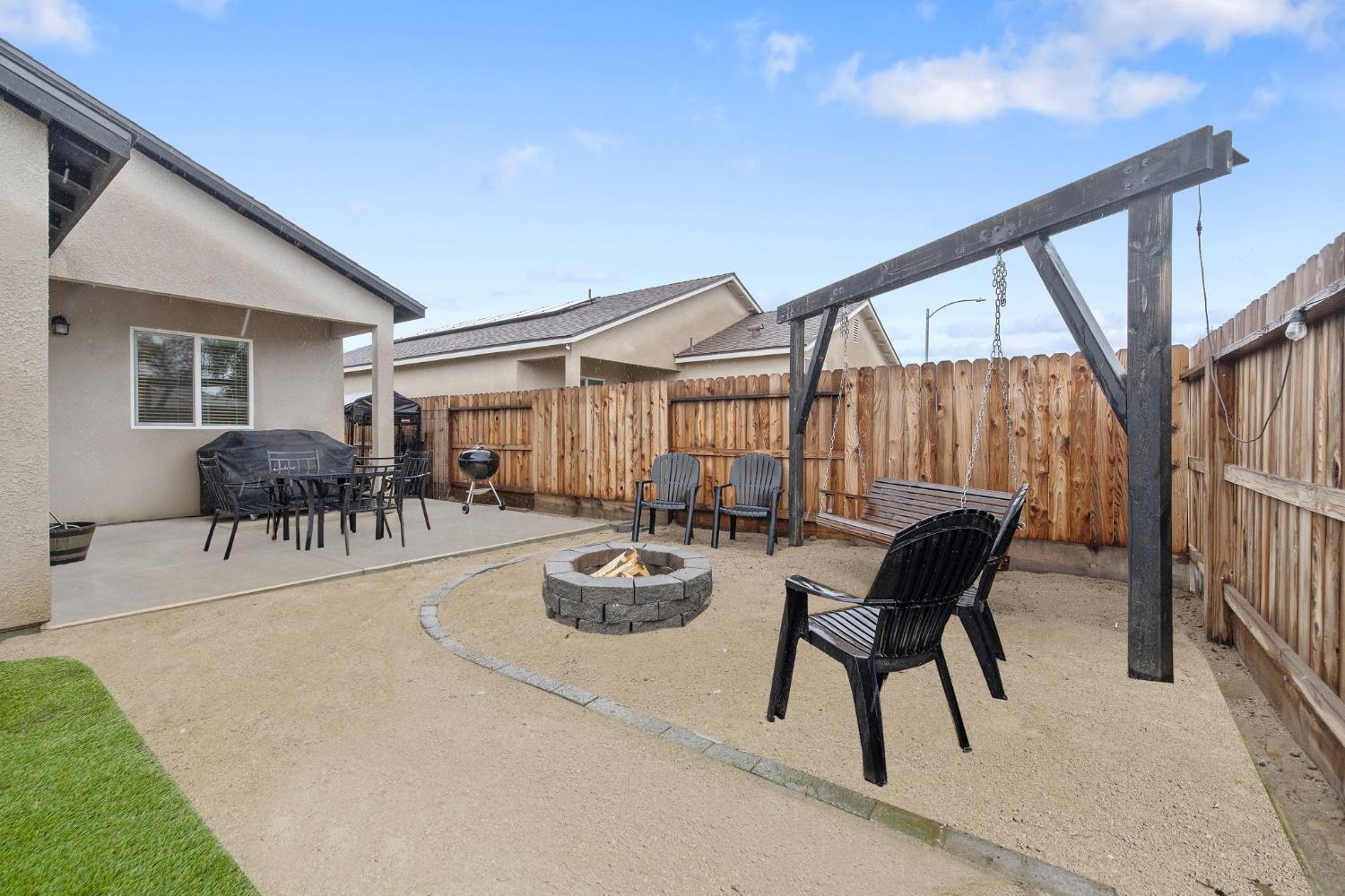 535 Sandtrap Lane Lemoore, CA 93245 - Photo 33 of 36 a view of a patio with couches table and chairs and potted plants