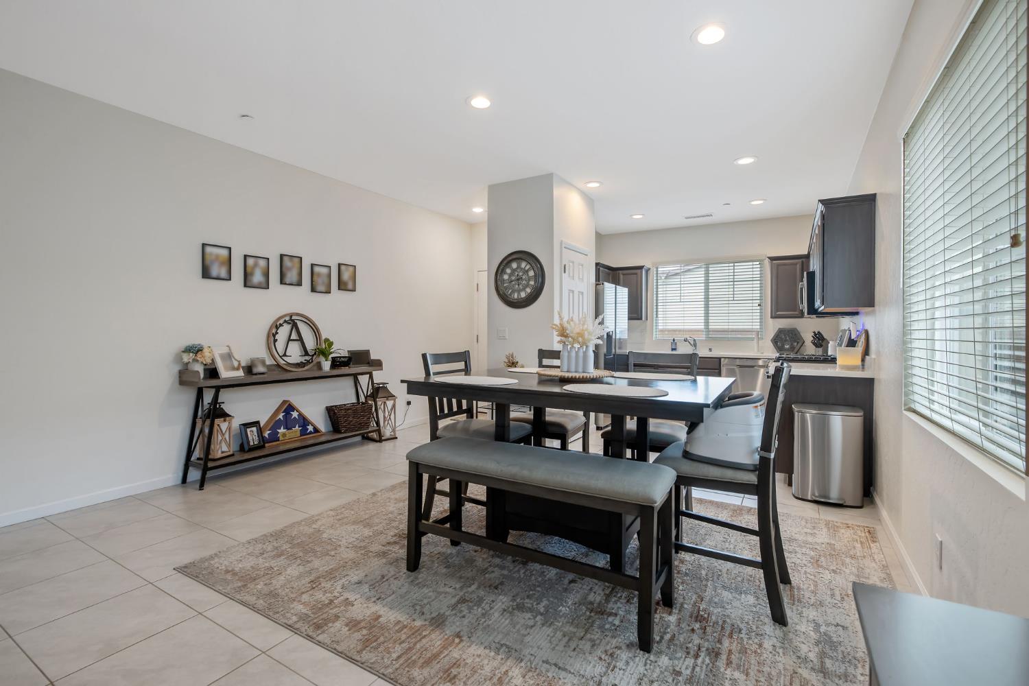 535 Sandtrap Lane Lemoore, CA 93245 - Photo 8 of 36 a living room with granite countertop furniture and a dining table with kitchen view