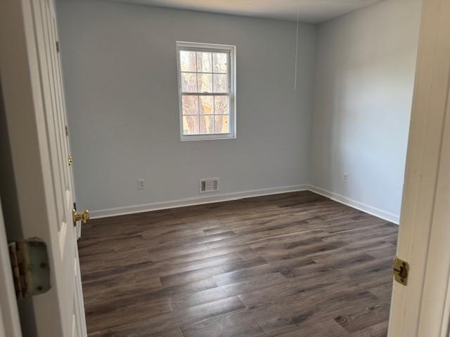 539 Faulkner Street Cleveland, GA 30528 - Photo 20 of 25 an empty room with wooden floor and windows