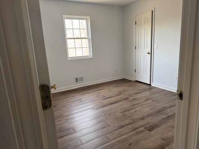 539 Faulkner Street Cleveland, GA 30528 - Photo 21 of 25 an empty room with wooden floor and windows