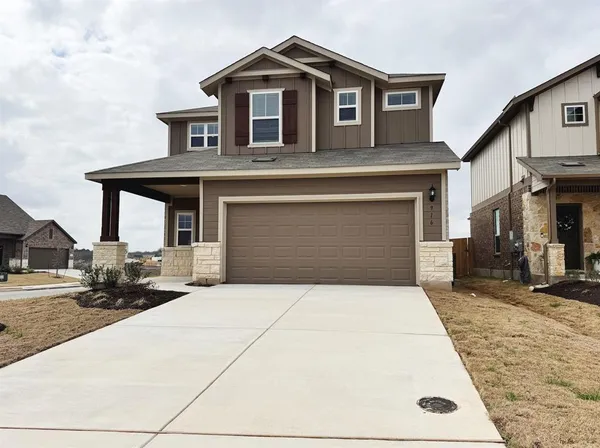 a front view of a house with yard