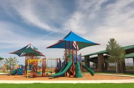 a view of a park with swings and slides