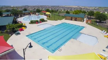 an aerial view of a house with a swimming pool