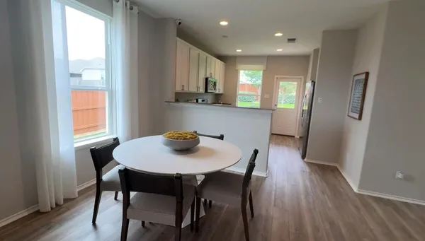 a view of a dining room with furniture and wooden floor
