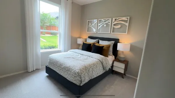 a bedroom with a bed and painting on the wall