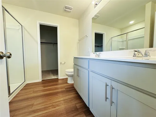 a view of an empty room with wooden floor