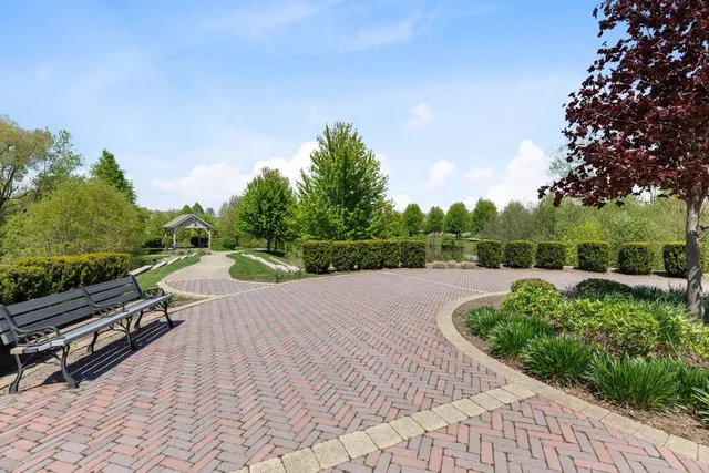 a front view of a house with a yard fountain