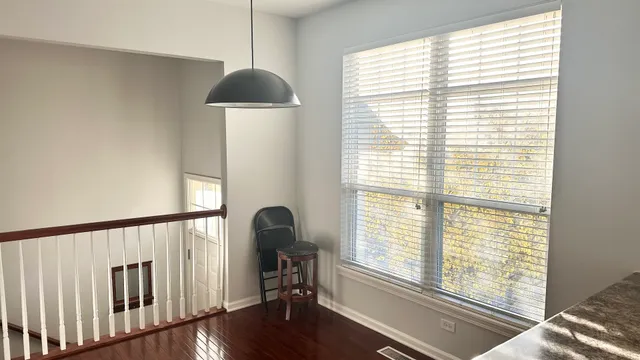 a front view of a house with wooden floor and a window