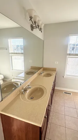 a bathroom with a tub sink and mirror