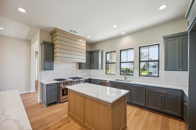 a kitchen that has a sink and a stove in it