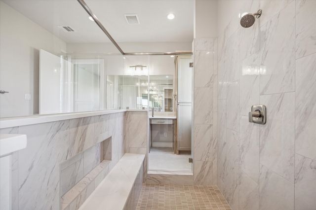 a bathroom with a shower and a sink