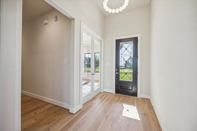 a view of an entryway with wooden floor