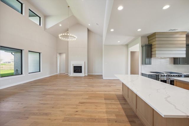 a large kitchen with kitchen island a sink stainless steel appliances and cabinets