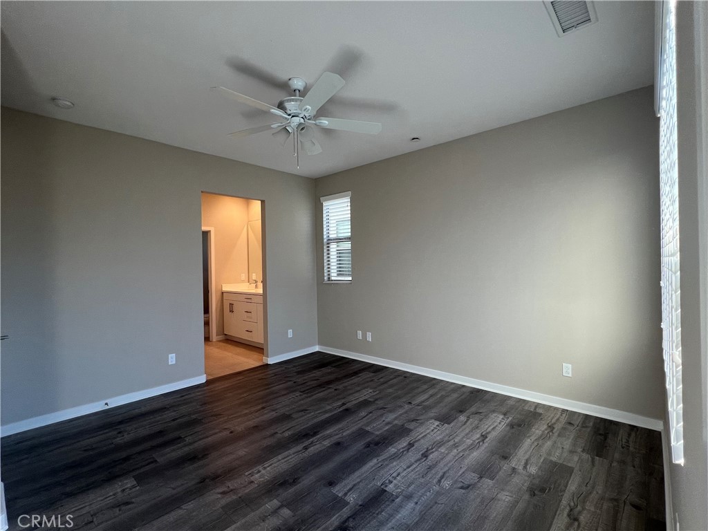 177 Magnet Irvine, CA 92618 - Photo 19 of 37 a view of an empty room with wooden floor and a window