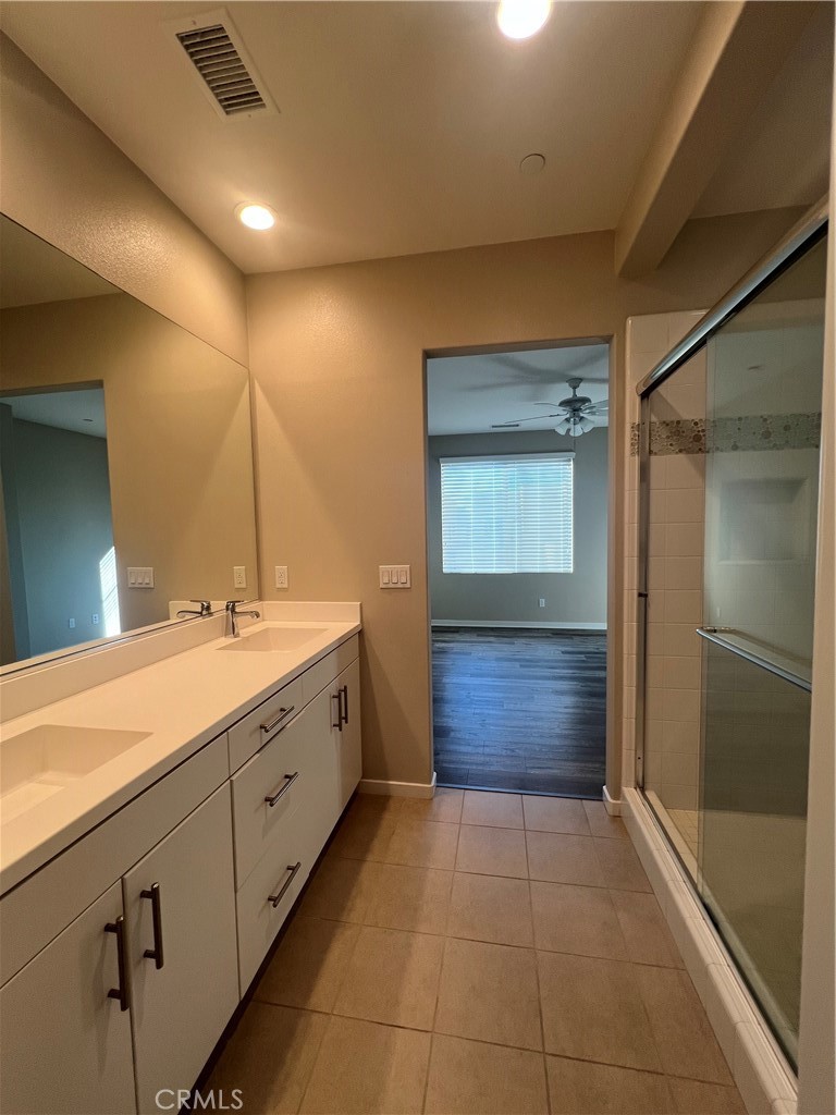 177 Magnet Irvine, CA 92618 - Photo 21 of 37 a bathroom with a mirror a double vanity sink and mirror