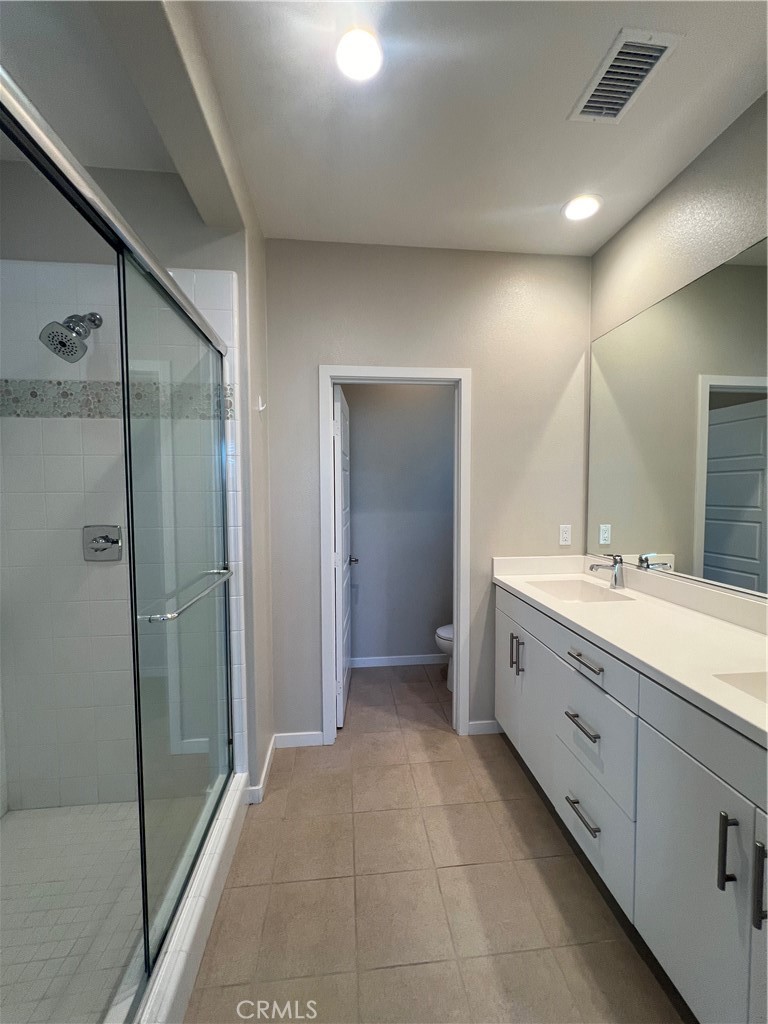 177 Magnet Irvine, CA 92618 - Photo 22 of 37 a spacious bathroom with a double vanity sink a large mirror and a shower